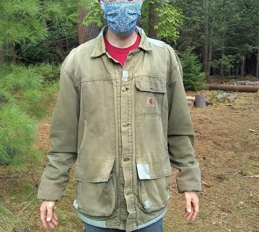 patch Carhartt Jacket on man in woods