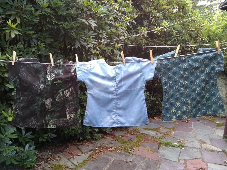 three children's shirts on a closeline