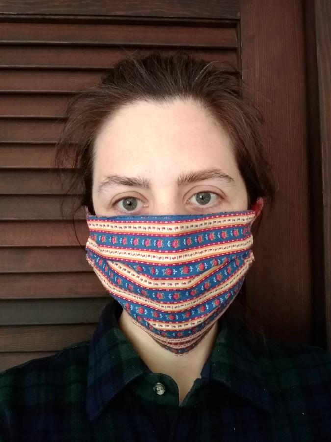 woman wearing pleated red-printed face mask, front view