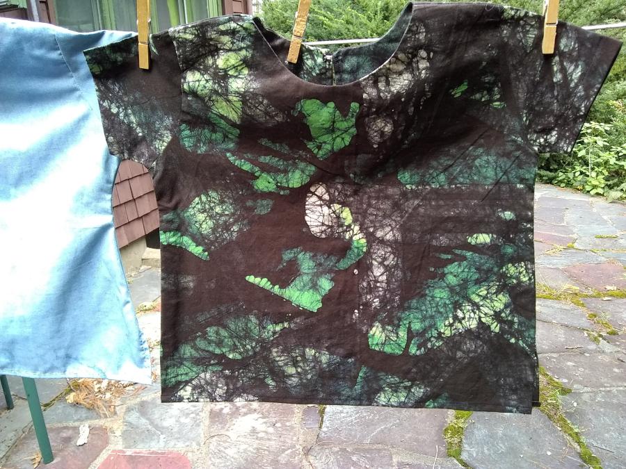 child's shirt, batik fabric and kurta style, on closeline, front view