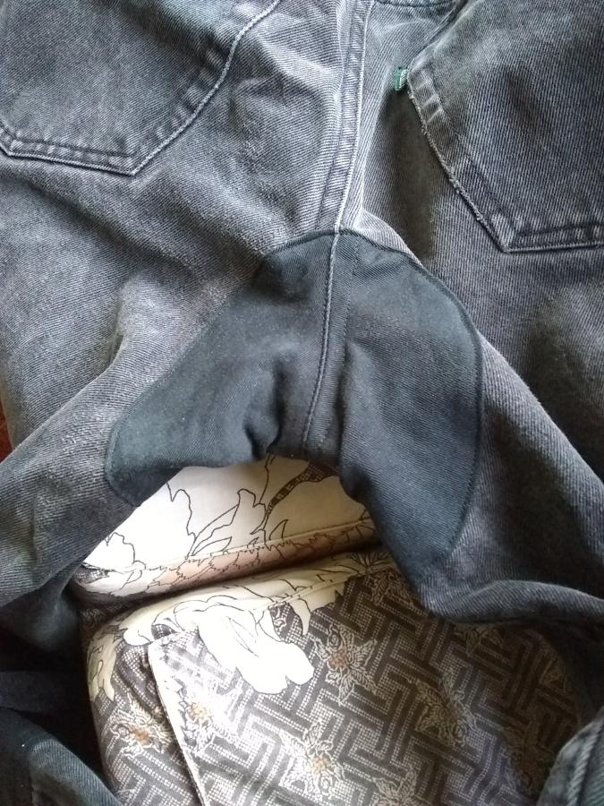 closeup view of crotch patch of black jeans, back