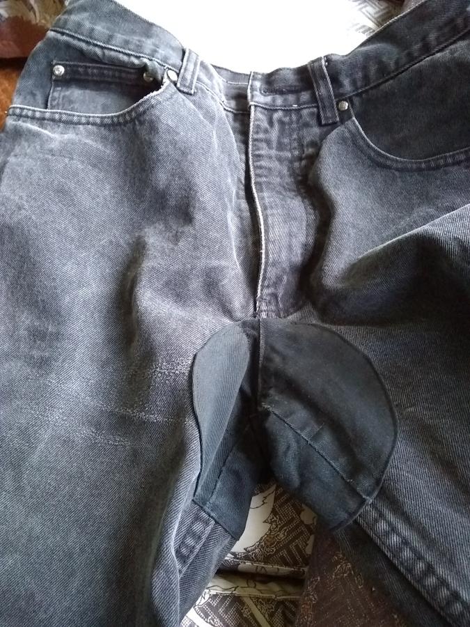 closeup view of crotch patch of black jeans, front