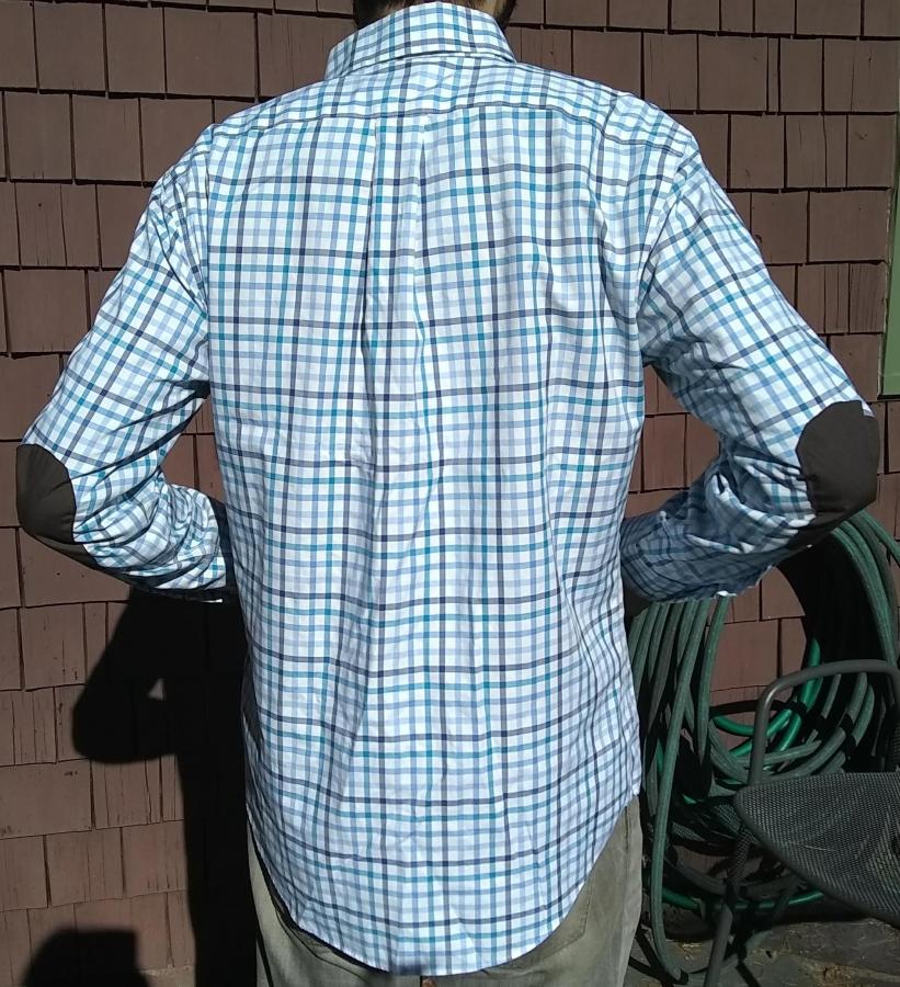 back view with elbows bent of blue plaid shirt with elbow patches, worn by man
