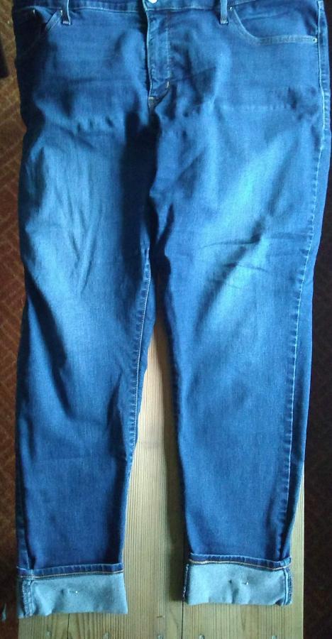 cuffed jeans on wooden background