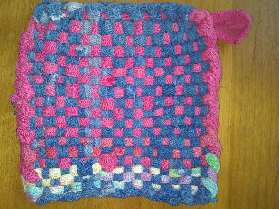 hand woven potholder in blue and pink with some multi