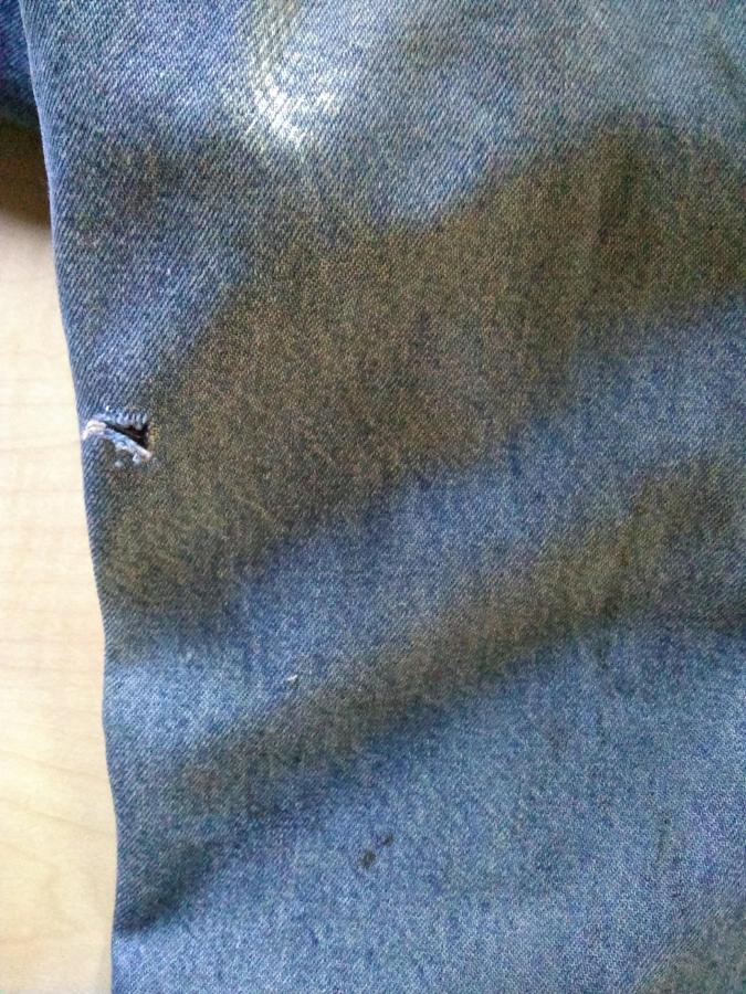 closeup of hole in blue jeans