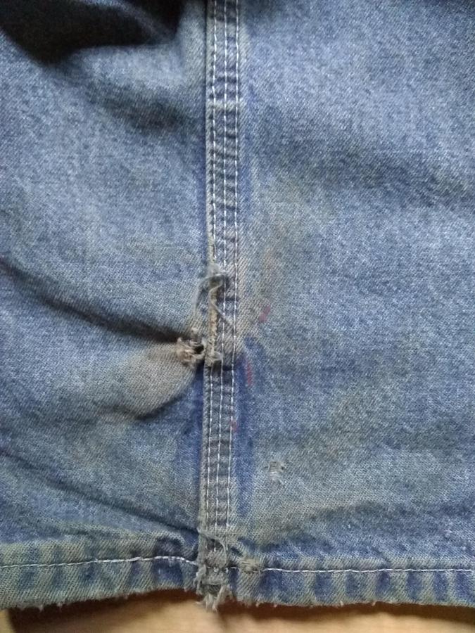 closeup of hole in blue jeans