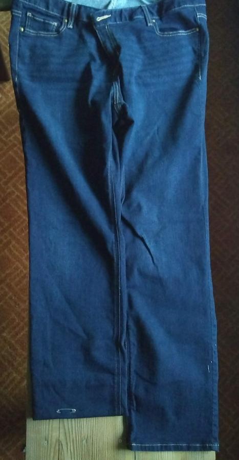 blue jeans with one leg folded up to indicate desired new hem