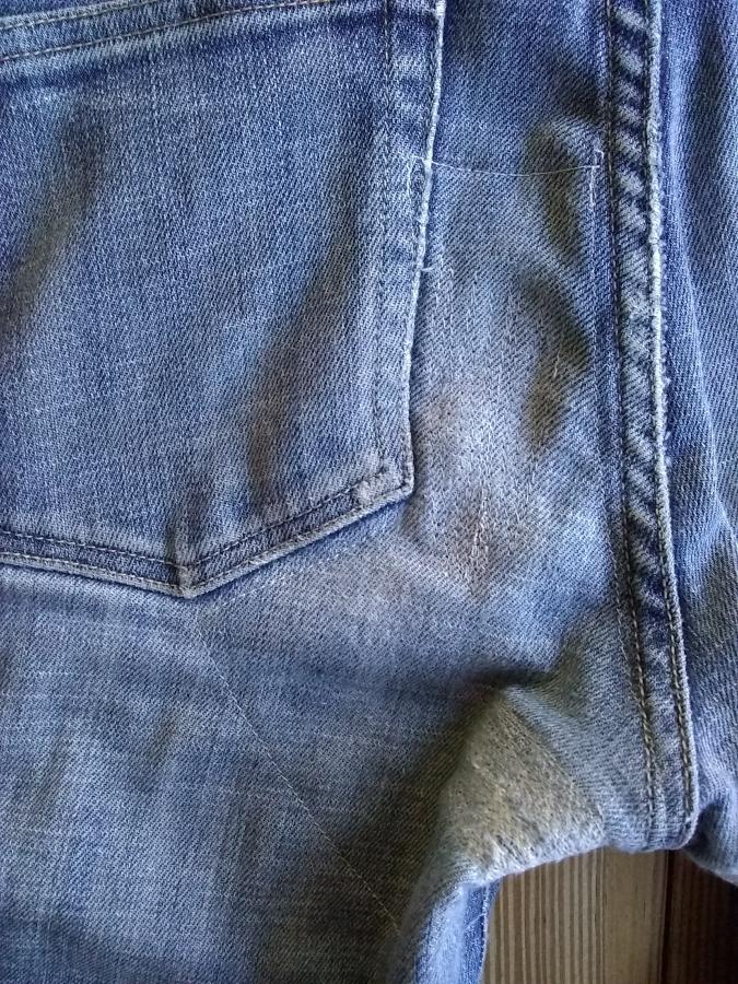 closeup of left backside of jeans with patch and darning