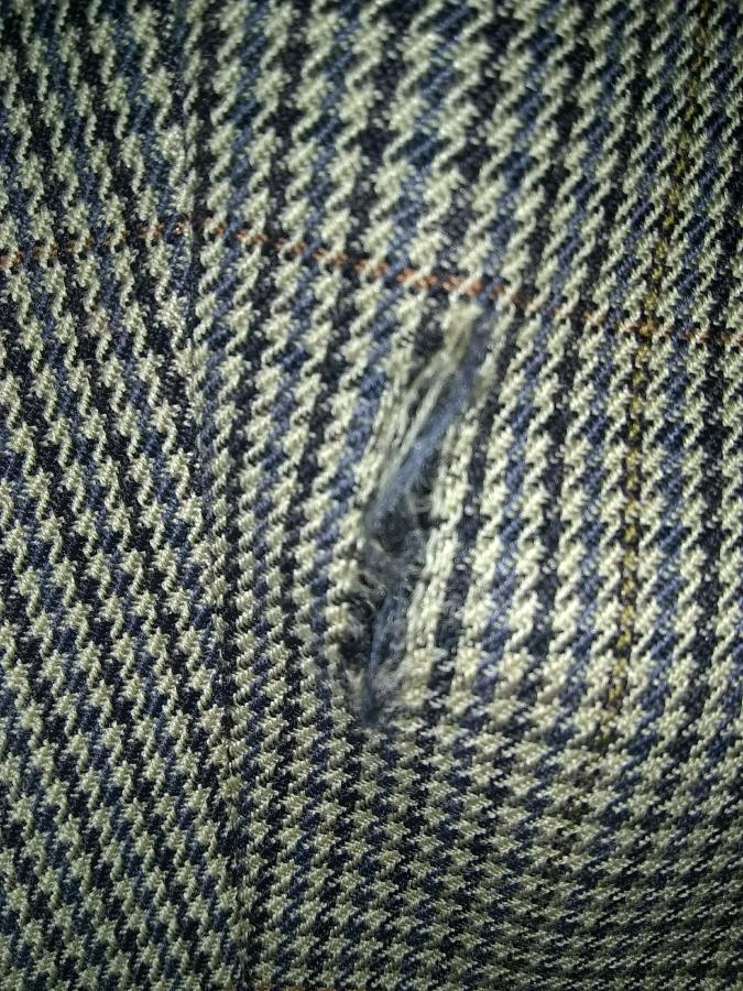 closeup of rip on sleeve of sport coat