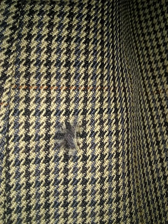 closeup of rip in sleeve of sport coat