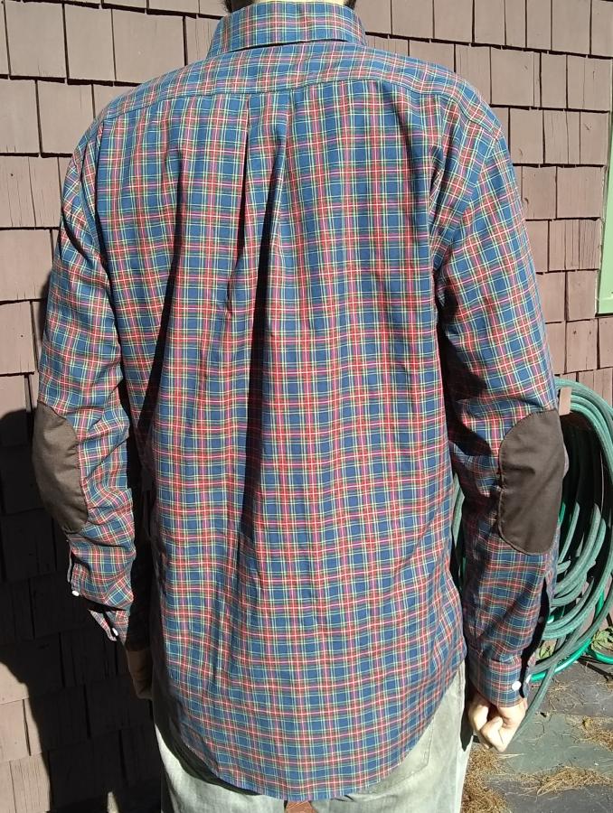 back view with of red plaid shirt with elbow patches, worn by man
