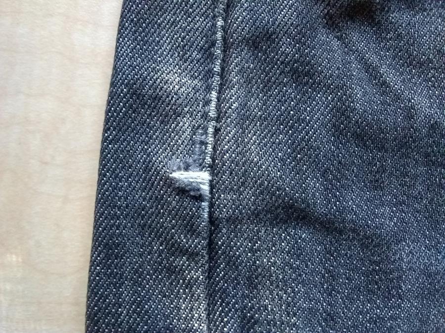 upper side of jeans with worn fabric at side seam