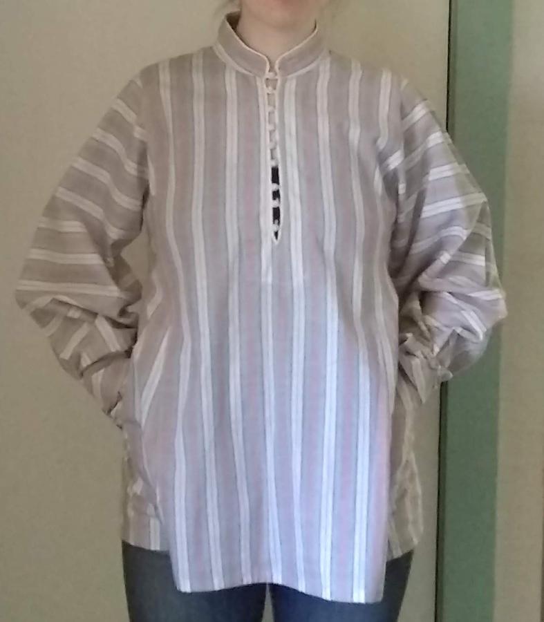 woman wearing slightly fitted striped woven cotton shirt with hands in hip pockets of shirt