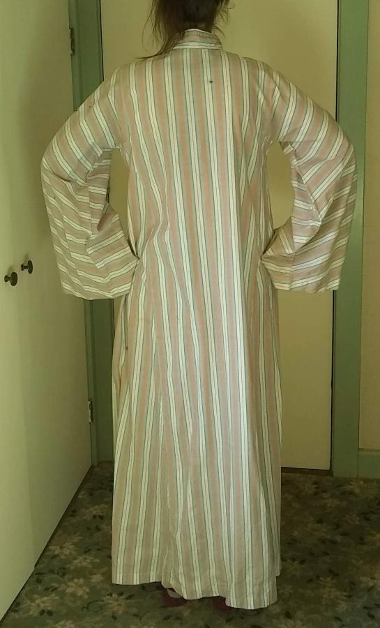 back view of woman wearing striped kaftan