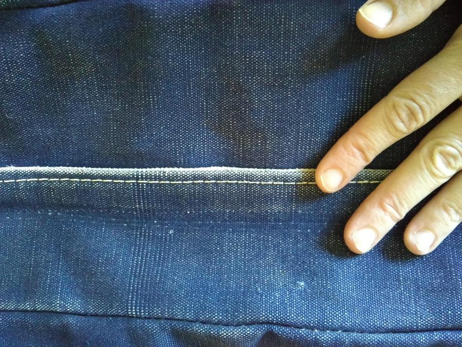 Closeup of new zipper in blue tote bag, closed and covered by flat