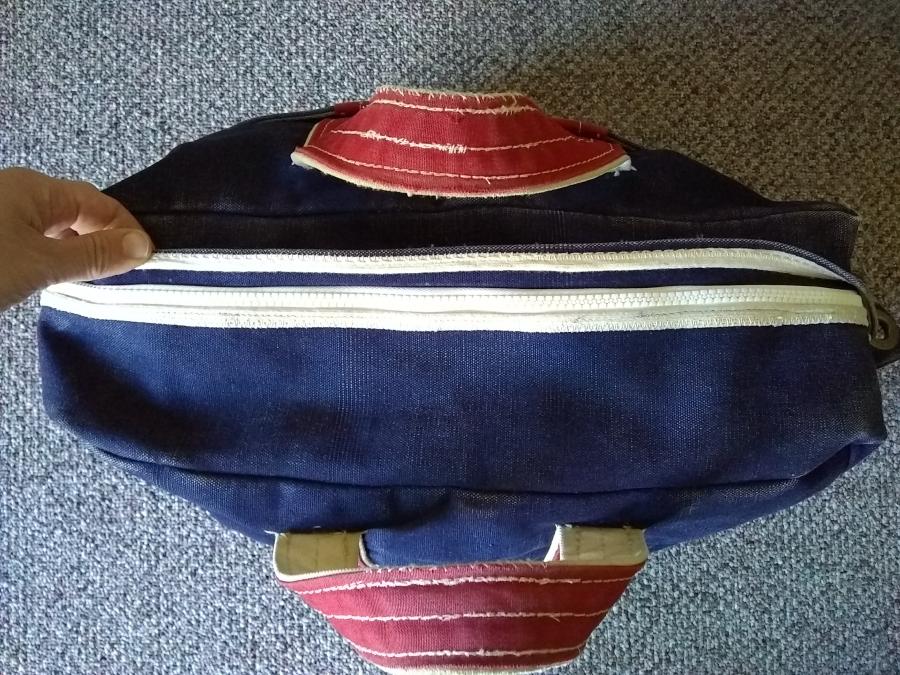 blue bag with red handles and new zipper with bag zipped up but zipper flap open