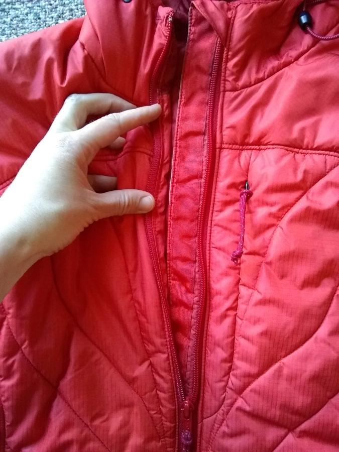 red winter jacket with replaced zipper, partially unzipped, to show front inside facing