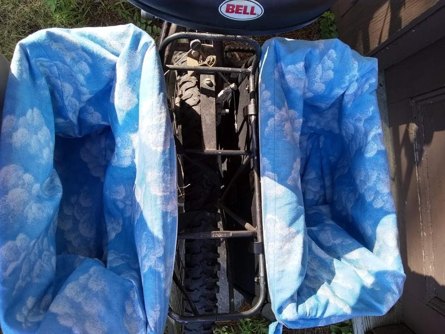 bike rack on back of bike, top view, with blue cloud print bags lining panniers, empty