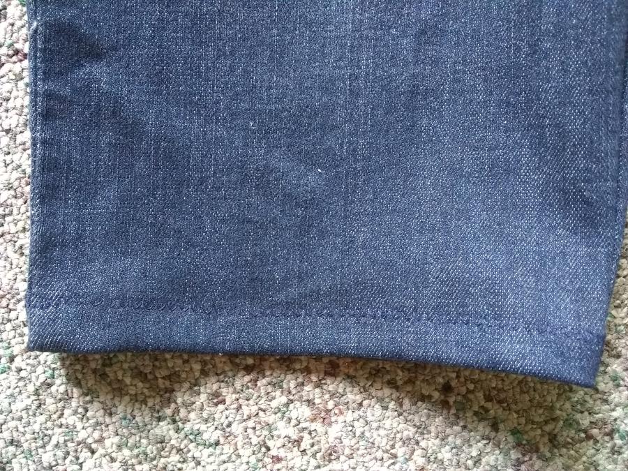 Closeup of bottom hem of one leg of the hemmed capris showing zig-zag stiches