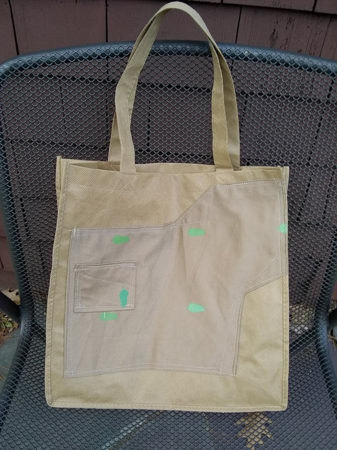 beige tote bag with monarch chrysallis silk screen patch sewed to one side