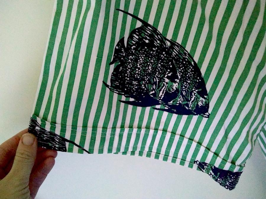 hand holding end of sleeve of bathrobe; sleeve has no fraying